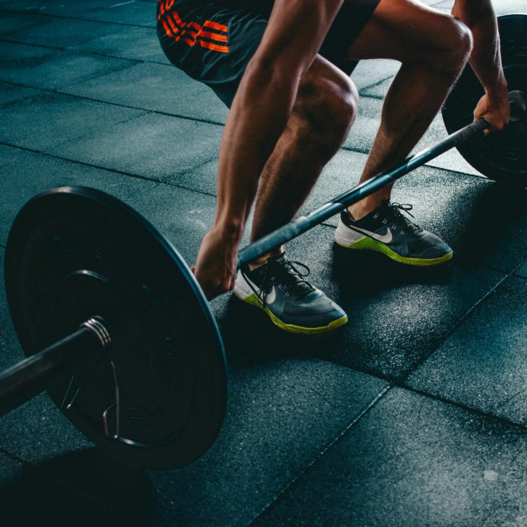 man squatting down performing a deadlift